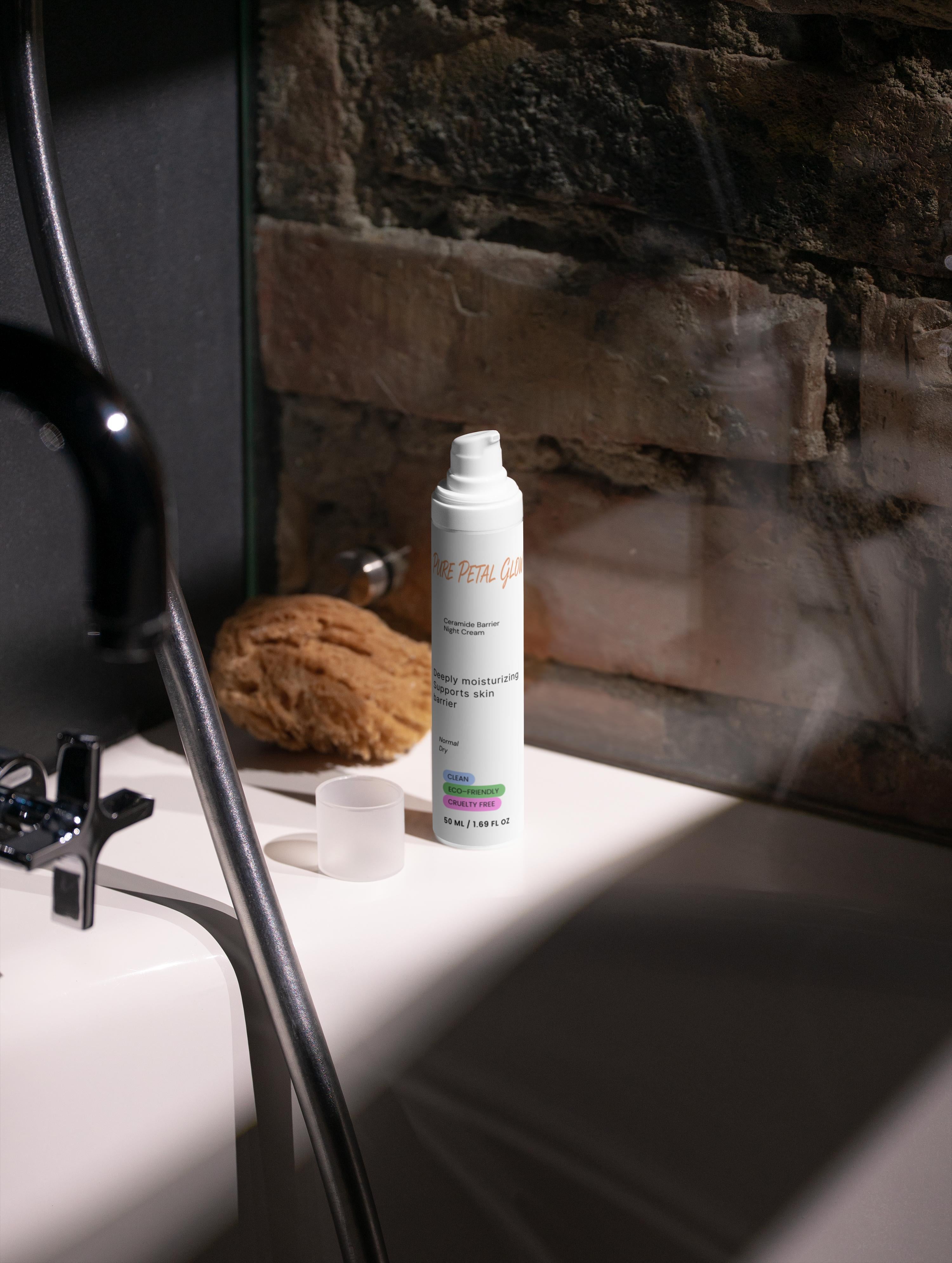White Ceramide Barrier Night Cream bottle on a bathroom counter with a stone wall background