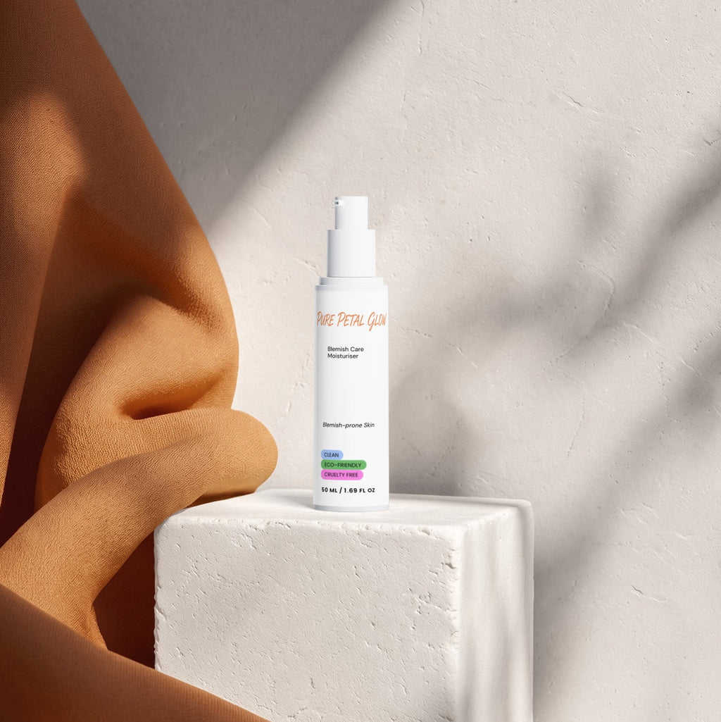 Pure Petal Glow Blemish Care Moisturizer bottle on a white pedestal beside draped orange fabric.